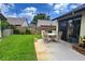 This backyard features a patio dining set on a concrete patio, framed by a wood fence and green lawn at 2459 Bay Berry Dr, Clearwater, FL 33763