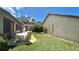 Outdoor patio and backyard perfect for entertaining with lush green grass and a backyard dining set at 2459 Bay Berry Dr, Clearwater, FL 33763