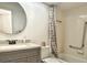 A well-lit bathroom with a shower/tub combination, a sleek gray vanity, and contemporary fixtures at 2459 Bay Berry Dr, Clearwater, FL 33763