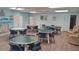This community room features light blue walls, various tables, and seating perfect for gatherings and activities at 2459 Bay Berry Dr, Clearwater, FL 33763