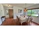 Cozy dining room with hardwood floors, a four-seater table, and a view of the outdoors at 2459 Bay Berry Dr, Clearwater, FL 33763