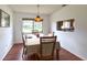 Bright dining area with wooden floors, table set for four, and an open view to the kitchen at 2459 Bay Berry Dr, Clearwater, FL 33763