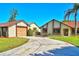 Inviting home featuring a well-manicured lawn, a spacious driveway, and an attached two-car garage at 2459 Bay Berry Dr, Clearwater, FL 33763