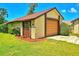 The two-car garage features natural wood, and it is accompanied by well-maintained landscaping at 2459 Bay Berry Dr, Clearwater, FL 33763