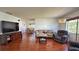 Open concept living room with hardwood floors, TV entertainment, and a dining room view at 2459 Bay Berry Dr, Clearwater, FL 33763