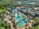 Beautiful aerial view of the community pool and clubhouse nestled among palm trees at 2495 Oakwood Preserve Dr, Wesley Chapel, FL 33543