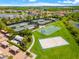 Aerial view showcases community recreation area with tennis, basketball, and sand volleyball courts at 2495 Oakwood Preserve Dr, Wesley Chapel, FL 33543