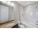 Well-lit bathroom featuring a shower-tub combo and granite vanity offering a clean and modern aesthetic at 2495 Oakwood Preserve Dr, Wesley Chapel, FL 33543