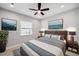Modern bedroom featuring neutral walls, ceiling fan, and a stylish gray, white and blue color scheme at 2495 Oakwood Preserve Dr, Wesley Chapel, FL 33543