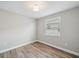 Well-lit bedroom with wood-look floors, featuring a large window providing natural light at 2495 Oakwood Preserve Dr, Wesley Chapel, FL 33543