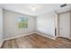 Bright bedroom with hardwood floors, neutral walls, and natural light from the window at 2495 Oakwood Preserve Dr, Wesley Chapel, FL 33543