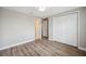 Bedroom with wood-look floors, double closets, and doors leading to other rooms at 2495 Oakwood Preserve Dr, Wesley Chapel, FL 33543