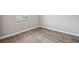 Bright bedroom features wood-style floors and a window offering natural light at 2495 Oakwood Preserve Dr, Wesley Chapel, FL 33543