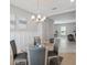 Open-concept dining area with elegant lighting and wainscoting details at 2495 Oakwood Preserve Dr, Wesley Chapel, FL 33543