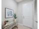 Bright entryway with neutral walls, glass-top accent table, and decor at 2495 Oakwood Preserve Dr, Wesley Chapel, FL 33543