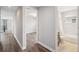 Bright hallway with access to a bedroom and a bathroom, offering convenience and accessibility within the home at 2495 Oakwood Preserve Dr, Wesley Chapel, FL 33543