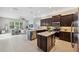 Modern kitchen with stainless steel appliances and island open to living area at 2495 Oakwood Preserve Dr, Wesley Chapel, FL 33543
