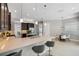 Bright, open kitchen featuring a quartz island, stainless appliances, and a view of the breakfast nook and front entryway at 2495 Oakwood Preserve Dr, Wesley Chapel, FL 33543