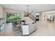 Spacious living room with tile floors and access to screened lanai at 2495 Oakwood Preserve Dr, Wesley Chapel, FL 33543
