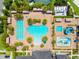 Aerial view of the community pool area featuring multiple pools, a water slide, and lounge chairs at 2495 Oakwood Preserve Dr, Wesley Chapel, FL 33543