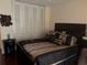 This cozy bedroom offers a comfortable bed and ample storage with its large, white-paneled closet at 3206 W Azeele St # 218, Tampa, FL 33609