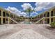 Charming courtyard view with landscaped walkway leading to a refreshing pool, offering an inviting outdoor space at 3206 W Azeele St # 218, Tampa, FL 33609