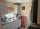 Functional kitchen with white cabinets, granite countertops, and stainless steel sink at 3206 W Azeele St # 218, Tampa, FL 33609