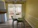 Bright dining area adjacent to kitchen, with table, chairs, and sliding glass door to porch at 3330 Monticello St, Holiday, FL 34690