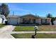 Charming single-story home featuring an attached garage and well-maintained front yard at 3330 Monticello St, Holiday, FL 34690