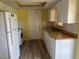 Efficient kitchen with wood countertops, white appliances, and ample cabinet space at 3330 Monticello St, Holiday, FL 34690