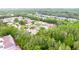 Expansive aerial view showcasing a serene community surrounded by lush trees and featuring a tranquil pond at 4332 Har Paul Cir, Tampa, FL 33614