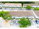 An aerial view displays well-maintained condo buildings surrounded by lush greenery and allocated parking spaces at 4332 Har Paul Cir, Tampa, FL 33614