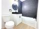 Bathroom featuring modern fixtures, black marble-look tile, new vanity with a sleek, round mirror, and a toilet at 4332 Har Paul Cir, Tampa, FL 33614