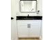 Modern bathroom featuring a white vanity with a black countertop and a sleek black framed mirror at 4332 Har Paul Cir, Tampa, FL 33614