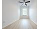 Bedroom features white walls, window with blinds, and wood-look floors at 4332 Har Paul Cir, Tampa, FL 33614
