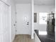 Bright entryway featuring light wood floors, a convenient coat closet, and a seamless transition to the kitchen area at 4332 Har Paul Cir, Tampa, FL 33614