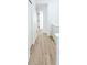 Upstairs hallway with wood-look flooring and white trim and doors at 4332 Har Paul Cir, Tampa, FL 33614
