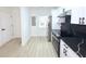 Modern kitchen features sleek black countertops, stainless steel appliances, and ample white cabinetry for storage at 4332 Har Paul Cir, Tampa, FL 33614