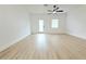 Large living room with white walls, ceiling fan, and patio door at 4332 Har Paul Cir, Tampa, FL 33614