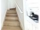 Staircase featuring wood steps with modern white handrail and lighting at 4332 Har Paul Cir, Tampa, FL 33614
