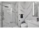Modern bathroom with white marble tile, a glass shower, and sleek white vanity and toilet at 449 S 12Th St # 504, Tampa, FL 33602