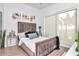 Comfortable bedroom featuring a stylish gray bed, wood floors, modern artwork, and light-filtering shades at 449 S 12Th St # 504, Tampa, FL 33602