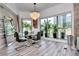 Dining room showcases a glass table, modern chandelier, and scenic views through large windows at 449 S 12Th St # 504, Tampa, FL 33602