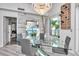 Stylish dining room features a glass table, chic lighting, and access to an outdoor balcony with lush greenery at 449 S 12Th St # 504, Tampa, FL 33602
