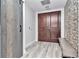 Bright entryway with double doors, stone accent wall and wood-look floors offers a warm welcome to the home at 449 S 12Th St # 504, Tampa, FL 33602
