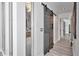 Hallway with plank floors, leading to an open bathroom, features a modern gray wood sliding barn door at 449 S 12Th St # 504, Tampa, FL 33602