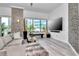 Open living room with large windows, stone accent wall, and sleek furnishings create a stylish and modern space at 449 S 12Th St # 504, Tampa, FL 33602