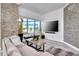 Contemporary living room featuring stone accent walls, sleek furnishings, and a large window with natural light at 449 S 12Th St # 504, Tampa, FL 33602