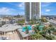 An amazing view of a tropical pool area below a condo tower, complete with palm trees and sunny skies at 449 S 12Th St # 504, Tampa, FL 33602