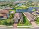 A picturesque aerial view of a residential area featuring a community lake and lush landscaping at 4506 Stickley Ct, Palmetto, FL 34221